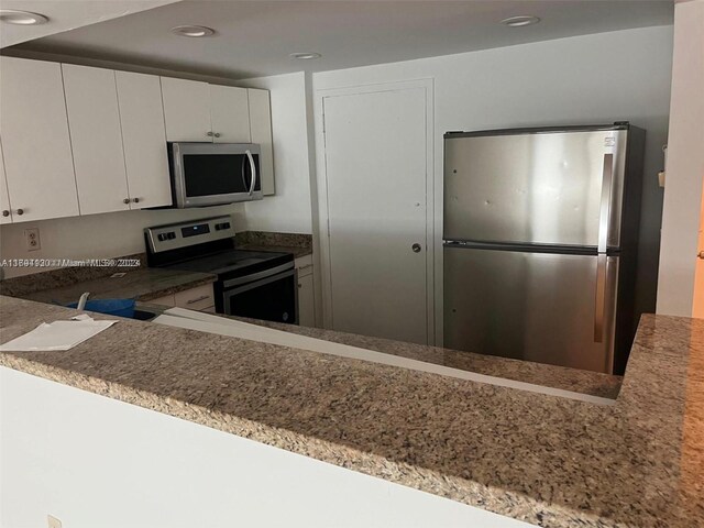 kitchen with white cabinetry and stainless steel appliances