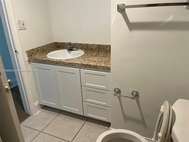 bathroom featuring tile patterned floors, vanity, and toilet