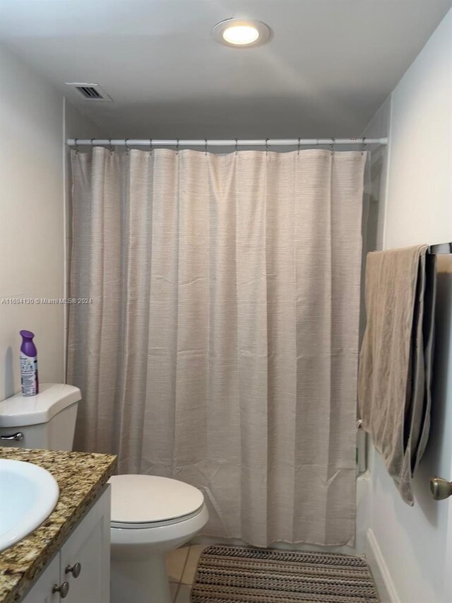 bathroom featuring tile patterned flooring, vanity, and toilet