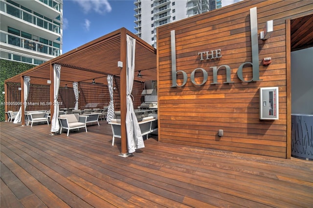 wooden terrace with an outdoor living space