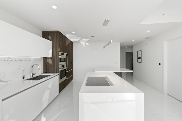 kitchen with white cabinets, black electric stovetop, a center island, and sink