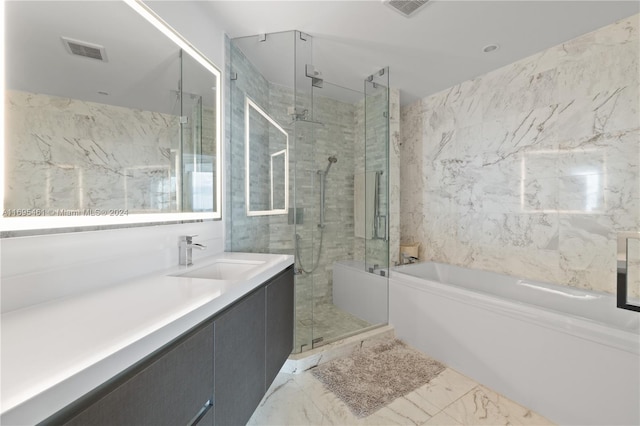 bathroom featuring vanity and shower with separate bathtub