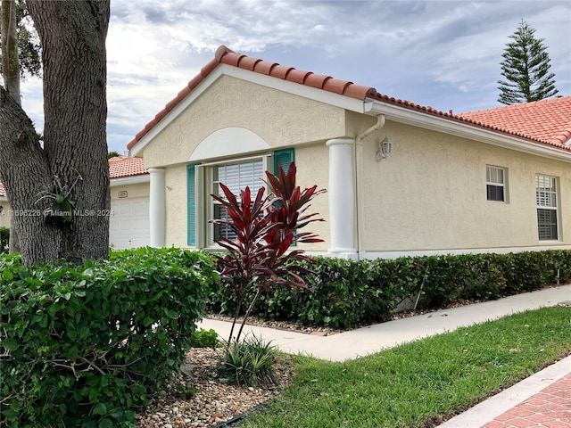 view of side of home with a garage