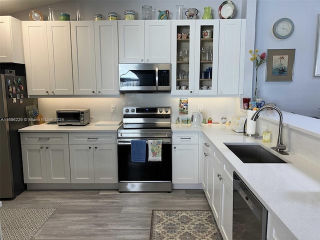 kitchen with white cabinetry, sink, and stainless steel appliances