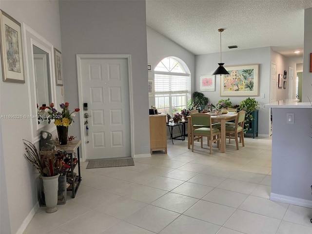 entrance foyer with light tile patterned floors and a textured ceiling