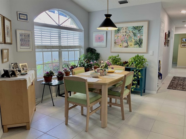 dining space featuring light tile patterned floors and a textured ceiling