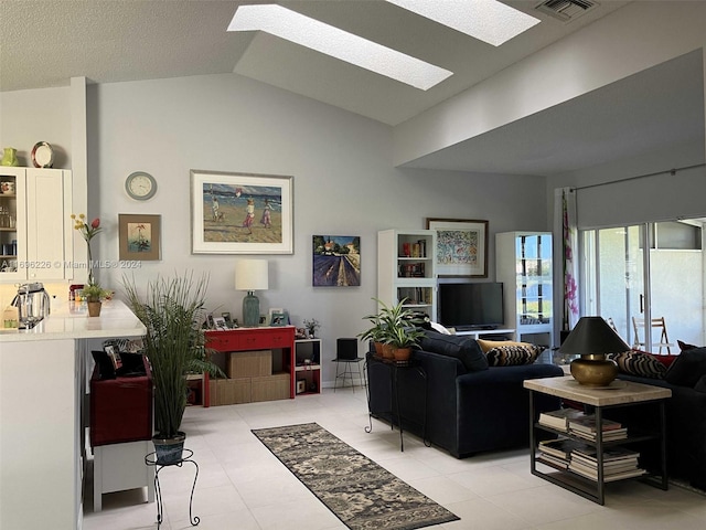 living room featuring vaulted ceiling with skylight