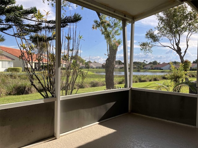 unfurnished sunroom with a water view