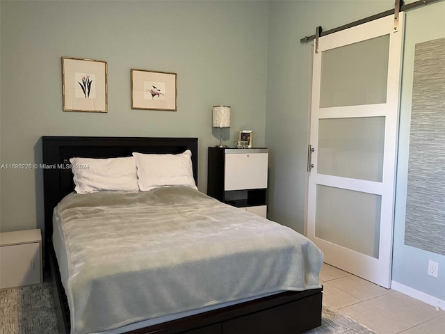 tiled bedroom with a barn door