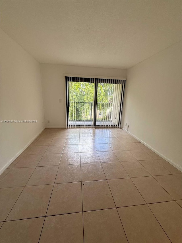 unfurnished room with light tile patterned floors