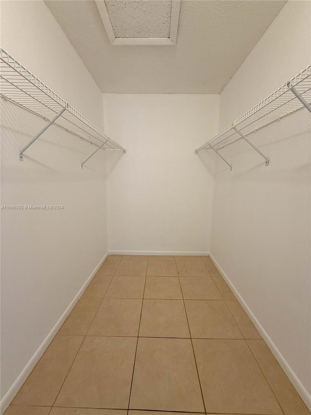 spacious closet featuring tile patterned flooring