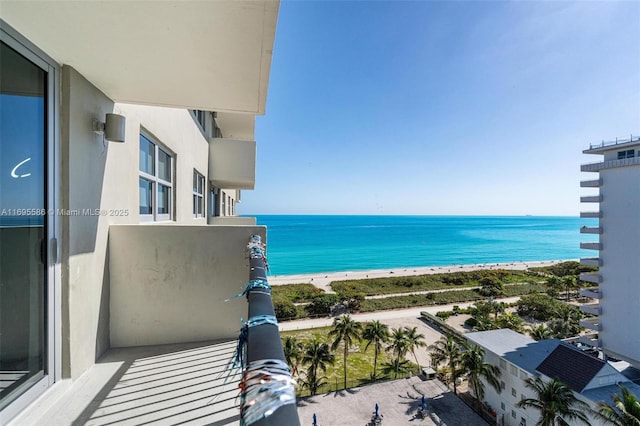 balcony featuring a beach view and a water view