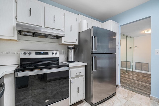 kitchen with white cabinetry, stainless steel appliances, and tasteful backsplash