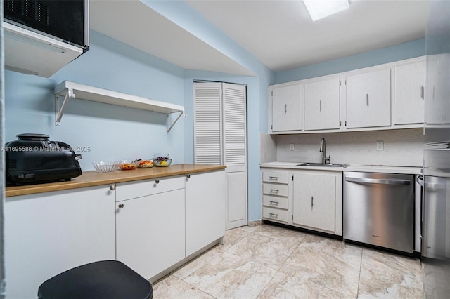 kitchen with backsplash, stainless steel dishwasher, sink, and white cabinets