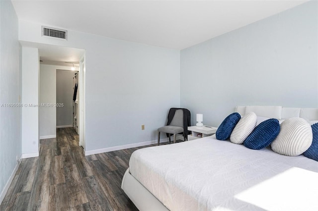 bedroom with dark wood-type flooring