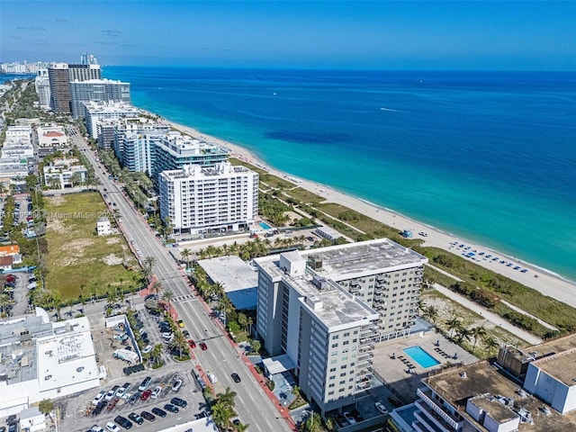 drone / aerial view featuring a view of the beach and a water view