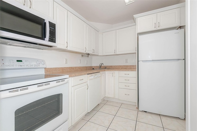 kitchen with white cabinets, white appliances, sink, and light tile patterned floors