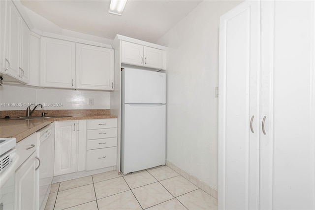 kitchen with white cabinets, white appliances, sink, and light tile patterned floors