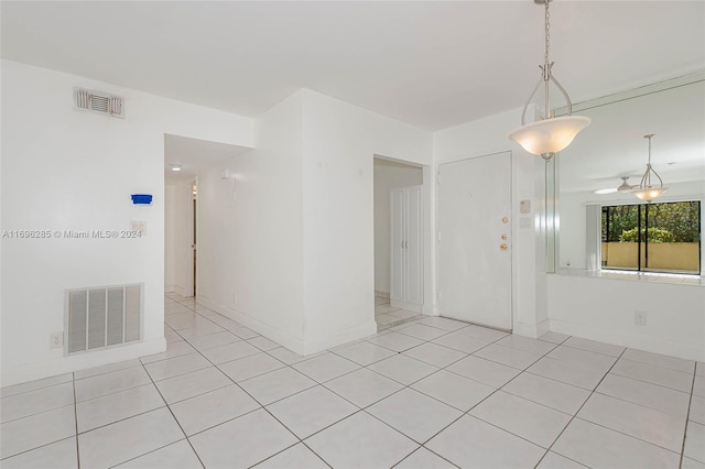 tiled empty room with ceiling fan