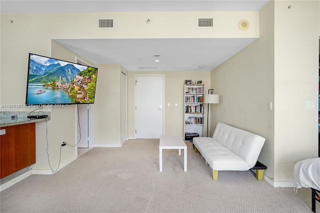 sitting room featuring light carpet