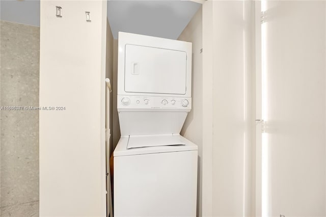 clothes washing area featuring stacked washer / drying machine