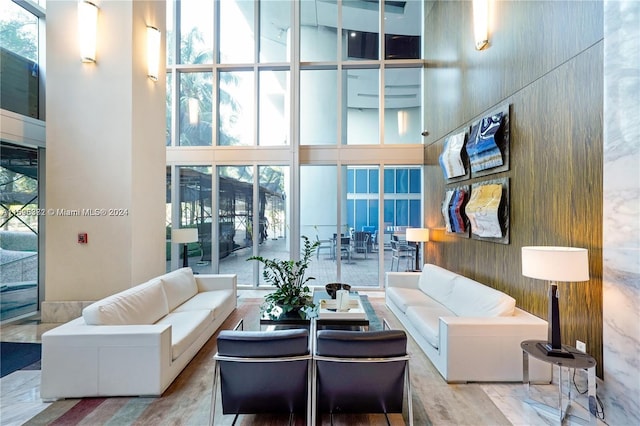 living room featuring a wealth of natural light and a towering ceiling