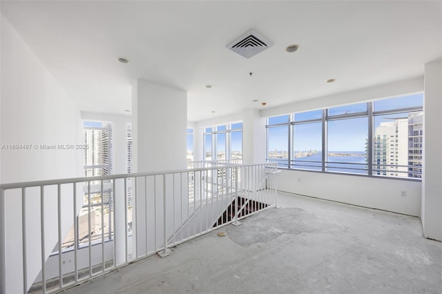 unfurnished room featuring visible vents and a water view