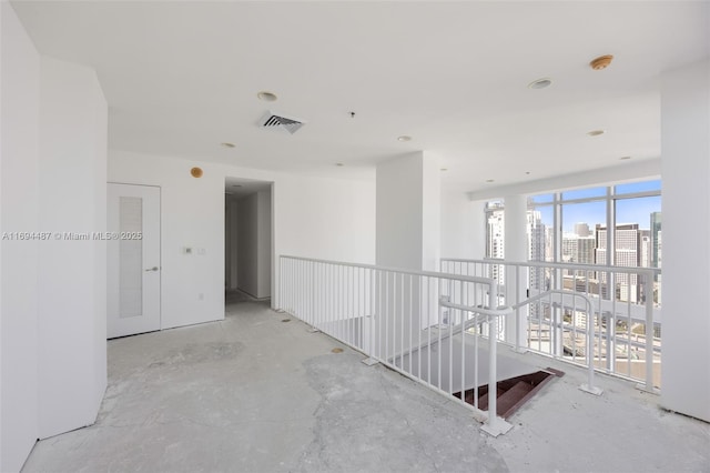 hall with an upstairs landing, visible vents, and a city view