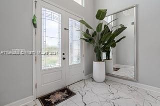 entrance foyer with french doors and plenty of natural light