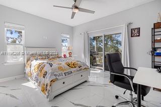 bedroom with access to exterior, ceiling fan, and multiple windows