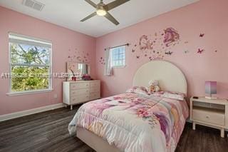 bedroom with dark hardwood / wood-style flooring, multiple windows, and ceiling fan