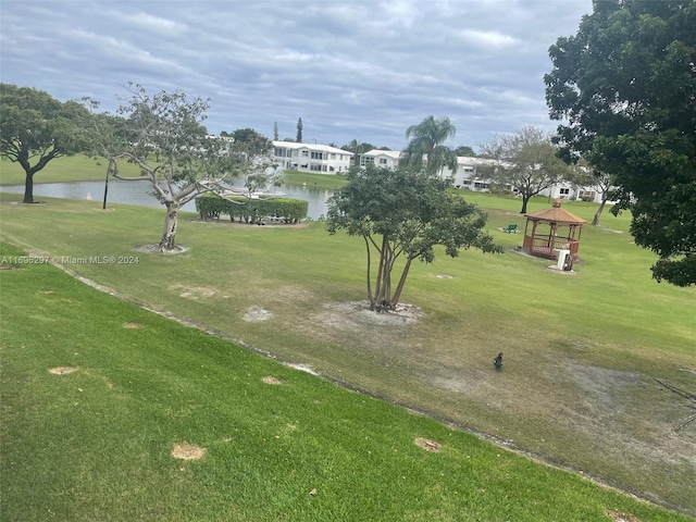 view of community with a gazebo, a water view, and a lawn