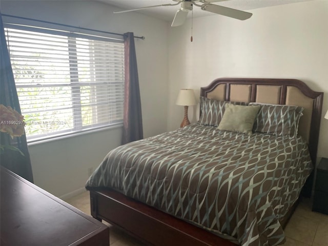 tiled bedroom with ceiling fan