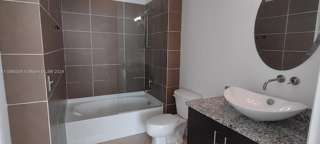 full bathroom with tile patterned flooring, vanity, toilet, and tiled shower / bath