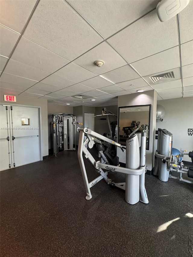 workout area featuring a paneled ceiling