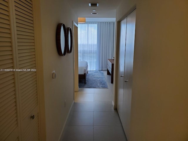 corridor with light tile patterned flooring