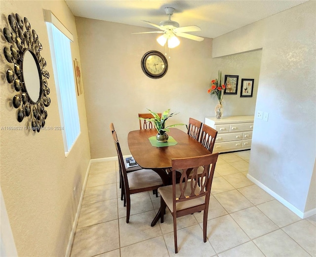 tiled dining room with ceiling fan