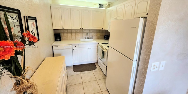 kitchen with tasteful backsplash, sink, white cabinets, and white appliances