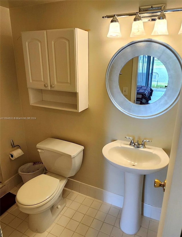 bathroom featuring tile patterned flooring, toilet, and sink