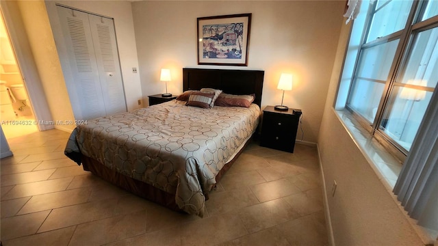 bedroom featuring light tile patterned floors and a closet