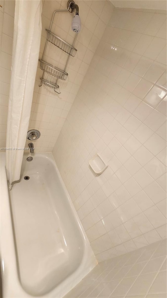 bathroom with shower / bathtub combination with curtain