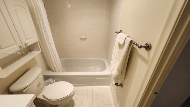 full bathroom featuring tile patterned floors, shower / tub combo with curtain, vanity, and toilet