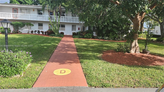 view of home's community with a yard