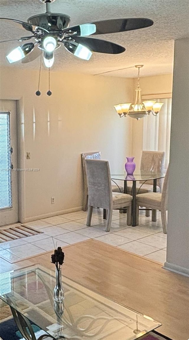 dining area with a textured ceiling, light hardwood / wood-style flooring, and ceiling fan