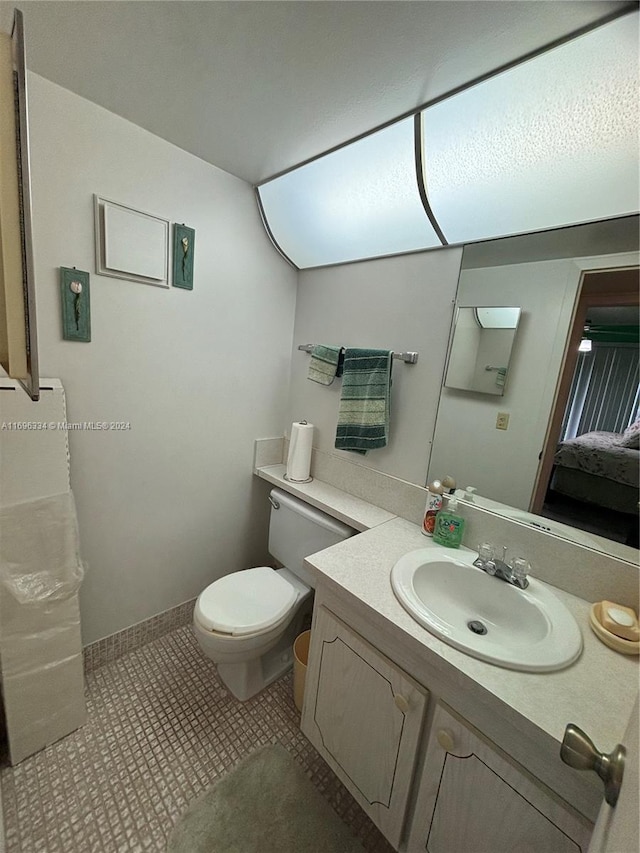 bathroom featuring tile patterned floors, vanity, and toilet