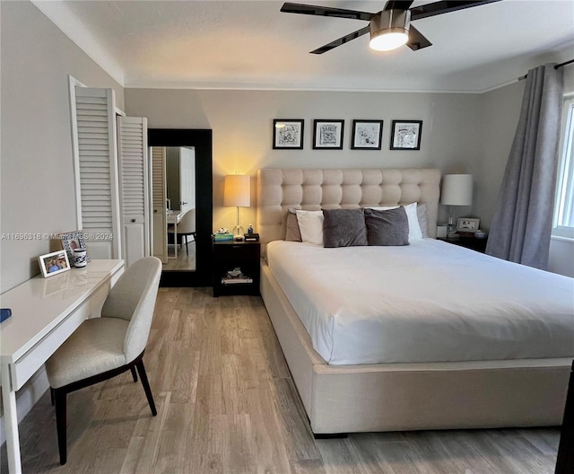 bedroom featuring wood-type flooring, a closet, and ceiling fan