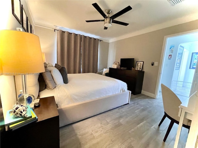 bedroom with hardwood / wood-style floors and ceiling fan