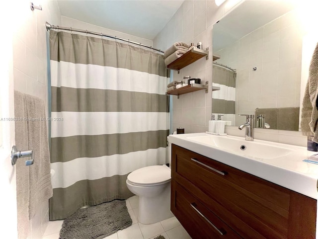 bathroom with vanity, tile walls, tile patterned flooring, toilet, and curtained shower