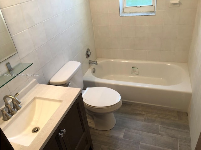 full bathroom with shower / bath combination, vanity, wood-type flooring, tile walls, and toilet