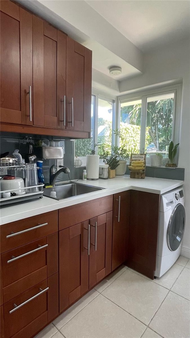 kitchen featuring light tile patterned floors, sink, and washer / clothes dryer